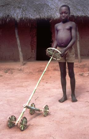 Boy with bamboo toy along the Zambezi River, Mozambique, 1962